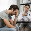 side-view-sad-man-doctor-s-appointment